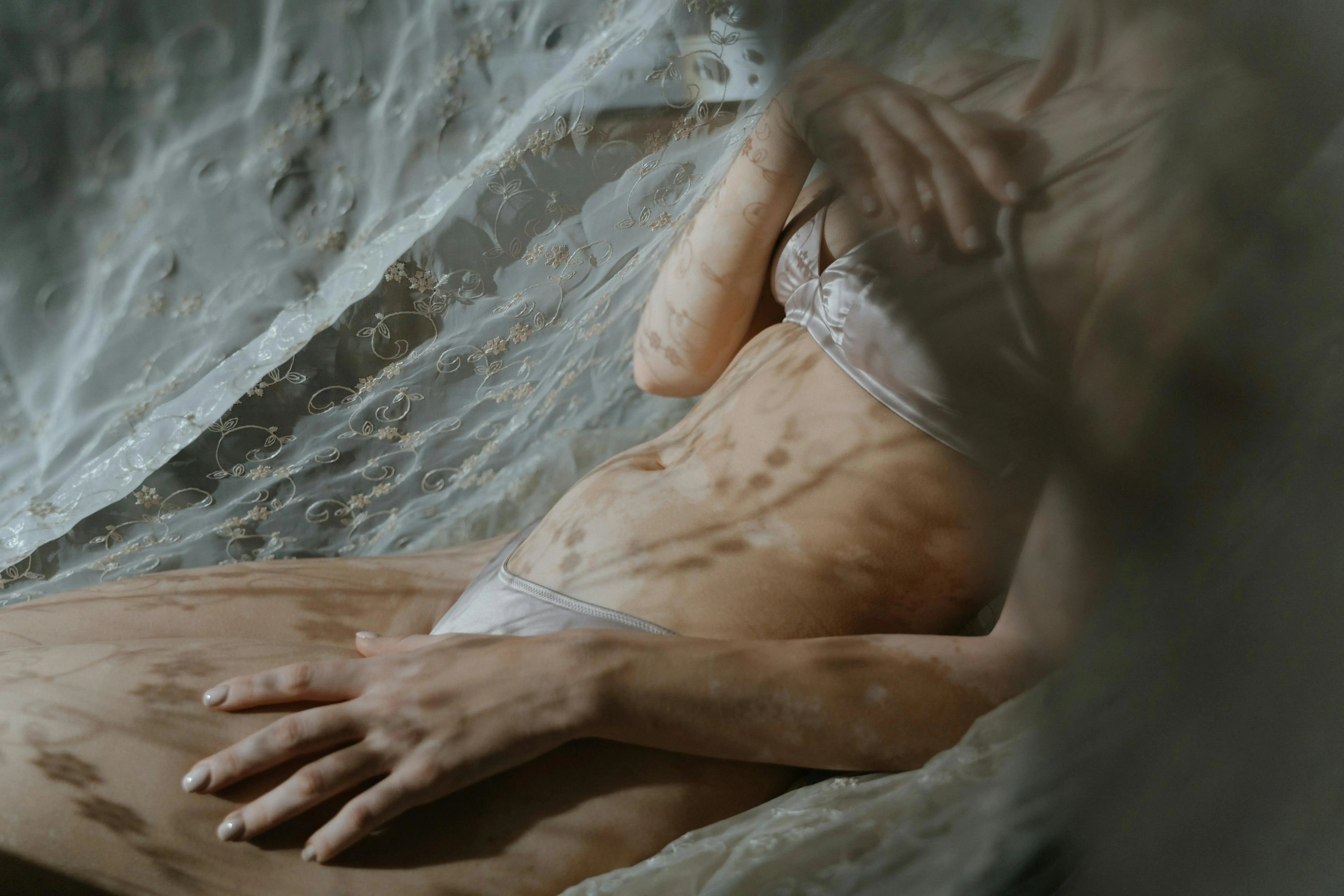 SHEVEREIGN editorial image expressing intimate body awareness, soft touch, and self connection through quiet sensual presence