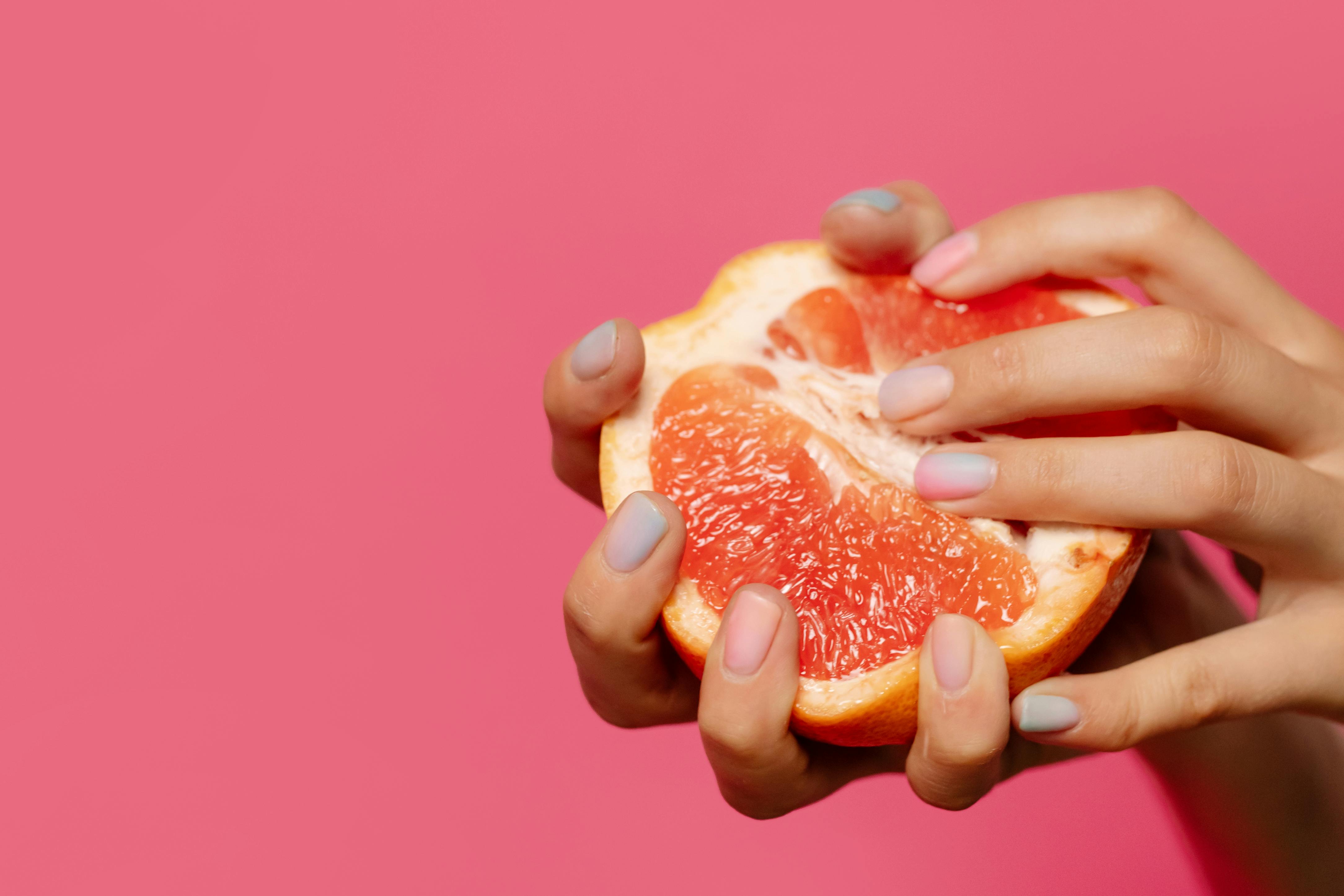 SHEVEREIGN blog banner image featuring a grapefruit in soft pink tones, symbolizing feminine vitality, the healing power of pleasure, and the connection between sexual wellness and mental health