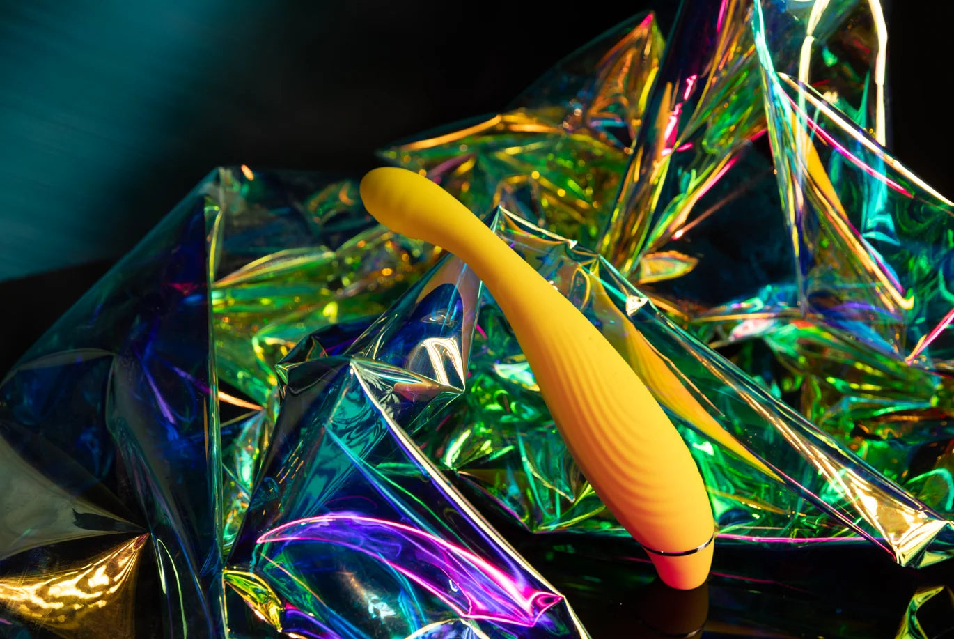SHEVEREIGN Fusion Bliss g spot vibrator displayed on vibrant iridescent fabric in the You May Also Like section, highlighting its curved golden design and modern intimate elegance