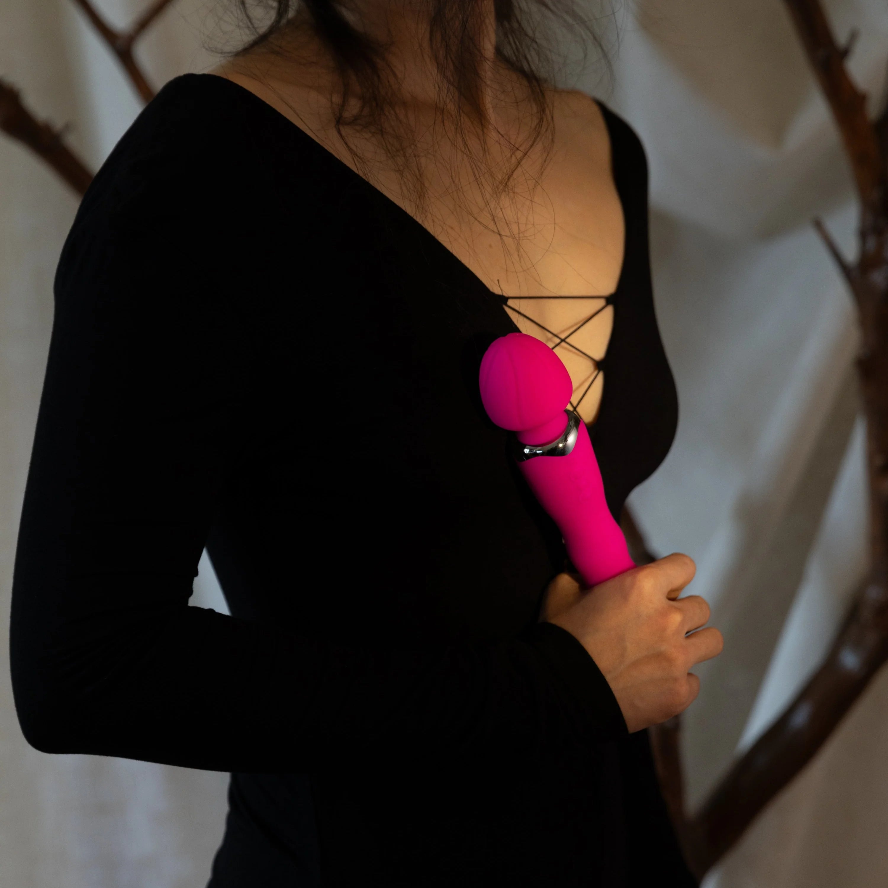 SHEVEREIGN woman holding a Mighty Touch wand vibrator, illustrating confidence and guidance in choosing the right pleasure toys