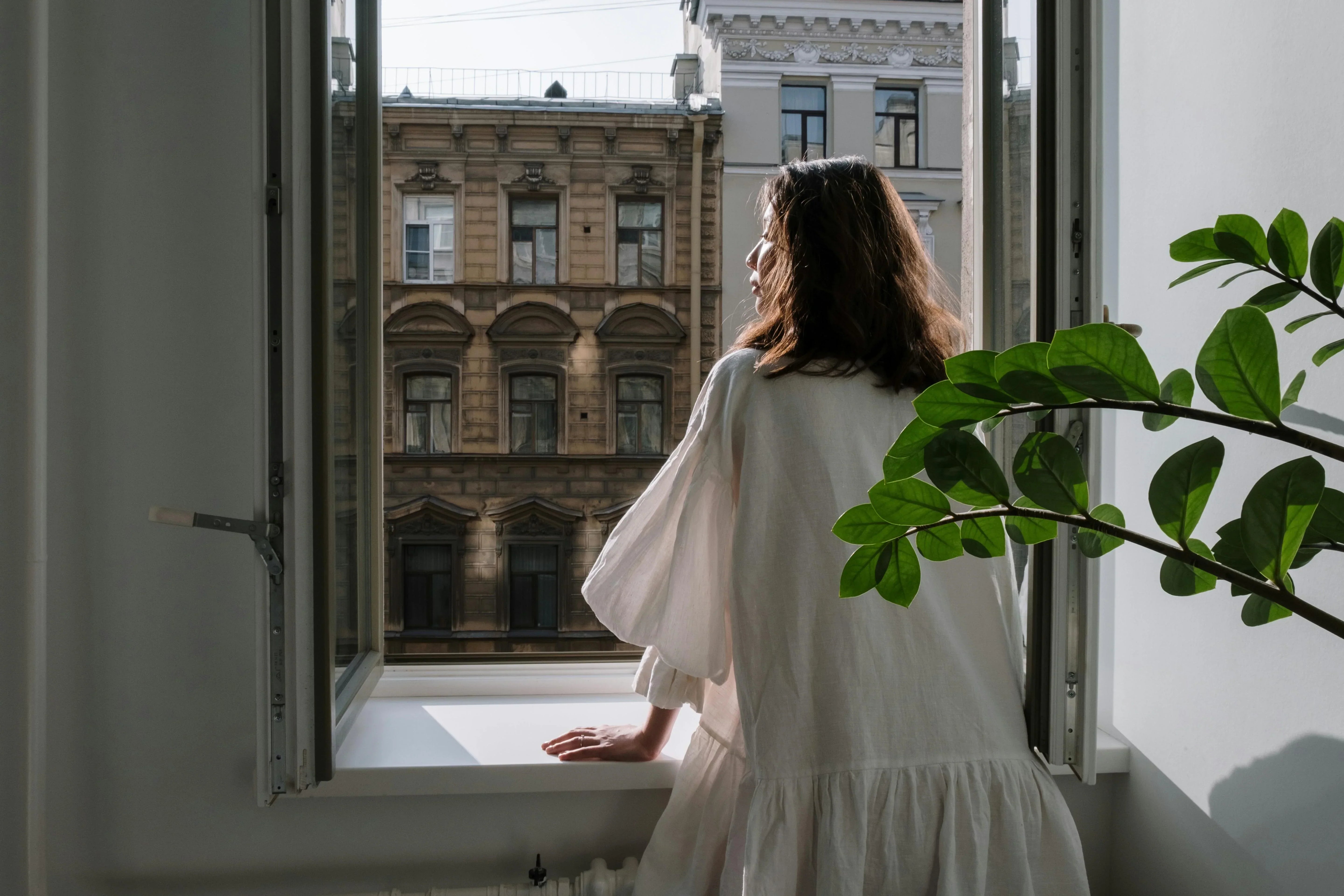 SHEVEREIGN blog banner image featuring a woman standing by a window in calm reflection, symbolizing emotional awareness, self-protection, and balance in casual relationships.