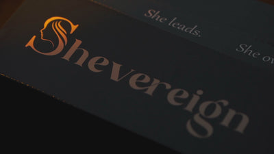 SHEVEREIGN logo packaging with soft golden light, symbolizing discreet luxury, feminine leadership