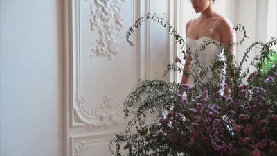 SHEVEREIGN OWN Series ambience video thumbnail featuring a woman in soft natural light surrounded by florals, expressing feminine confidence and modern intimate elegance