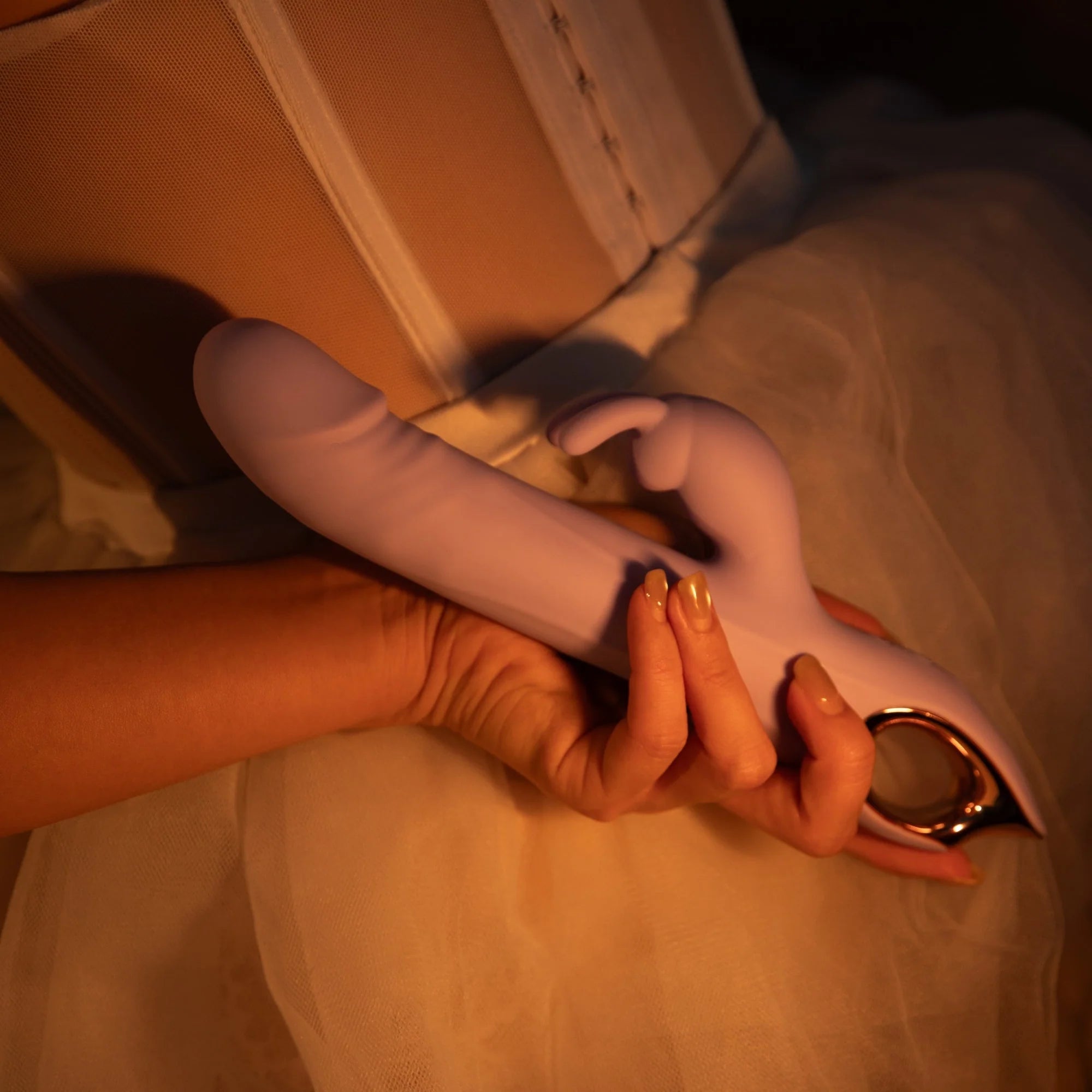SHEVEREIGN hand holding a Lilac Reverie rabbit vibrator, representing gentle guidance for women’s first pleasure exploration