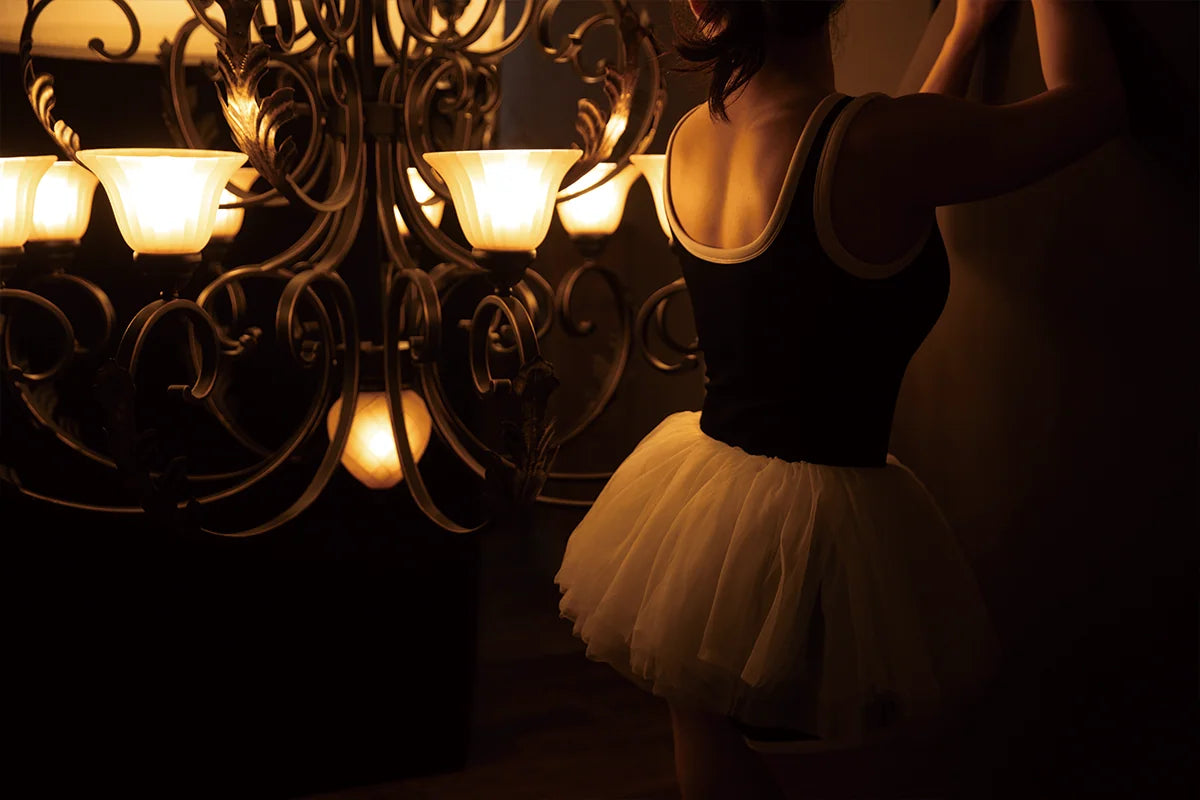 Atmospheric SHEVEREIGN lifestyle image featuring a woman in soft warm lighting, reflecting feminine elegance and the brand’s intimate design aesthetic